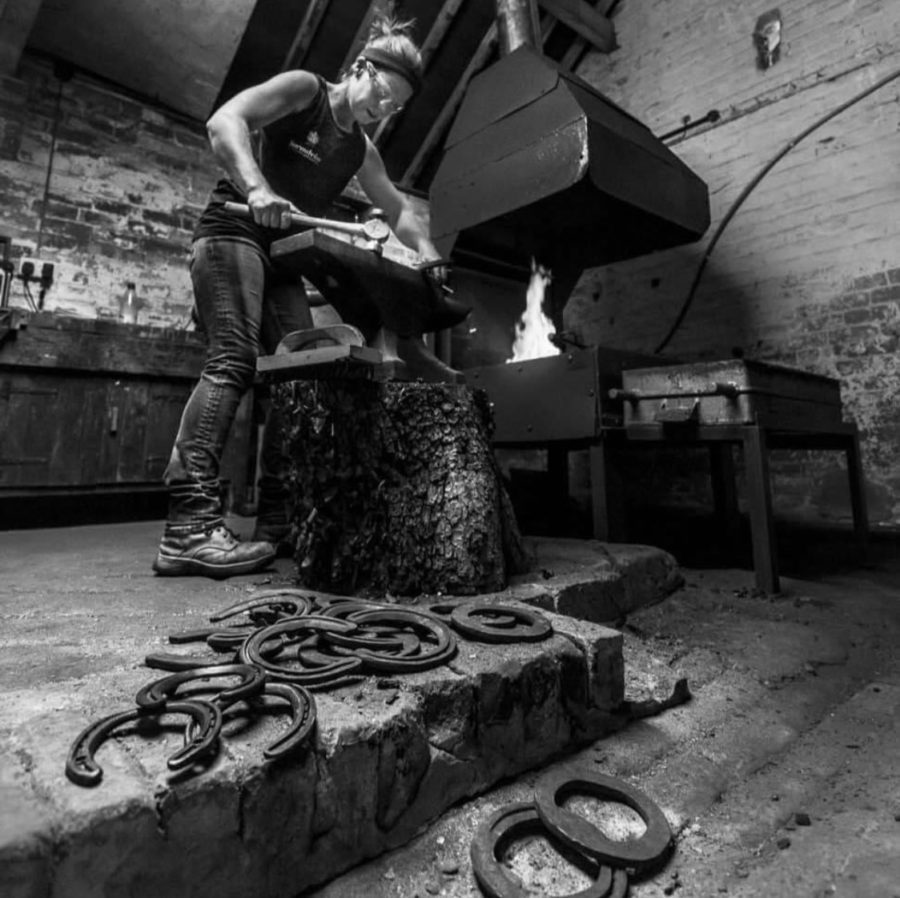 farrier working with anvil and hammer